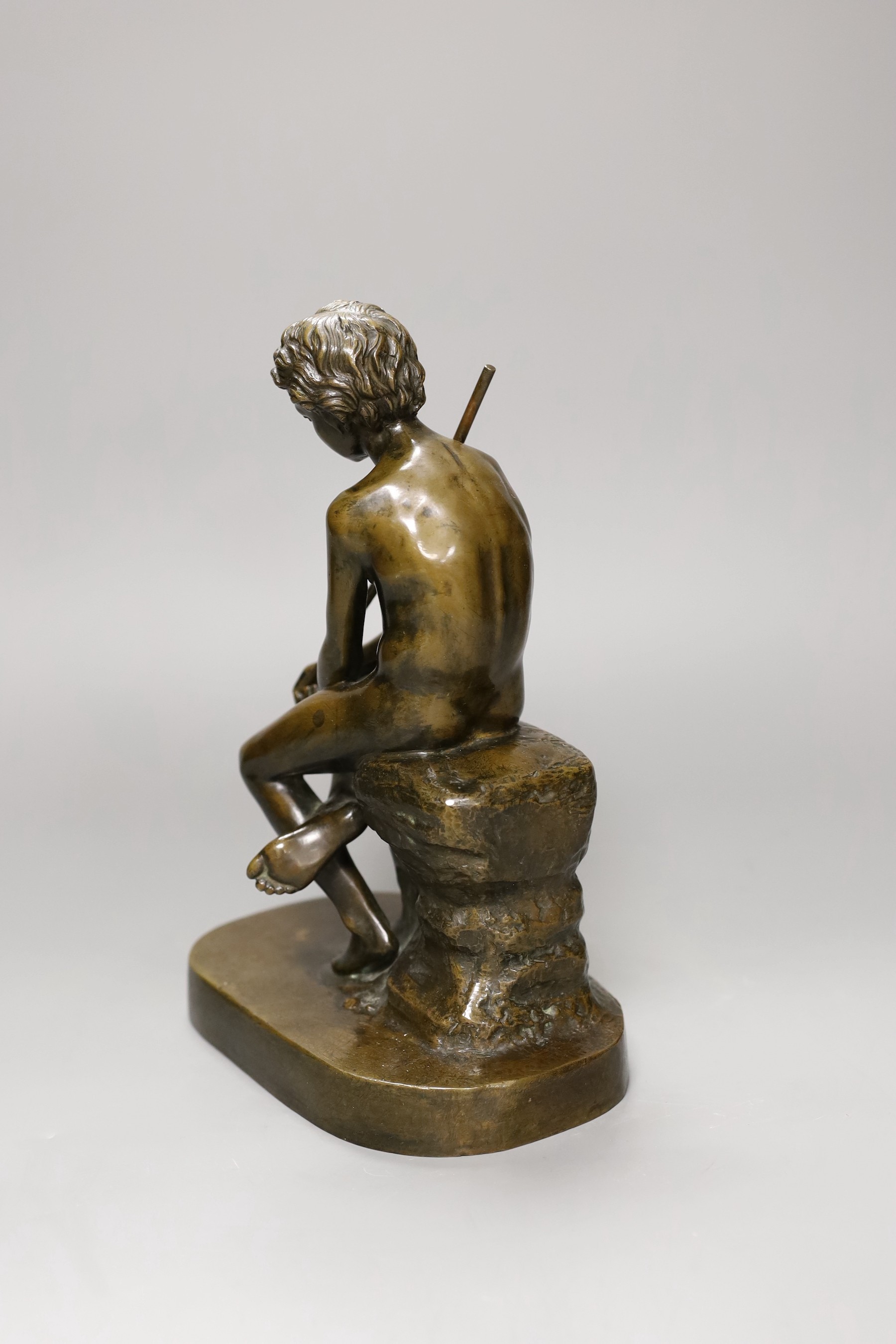 An early 20th century bronze figure of a fisherboy, 25cm